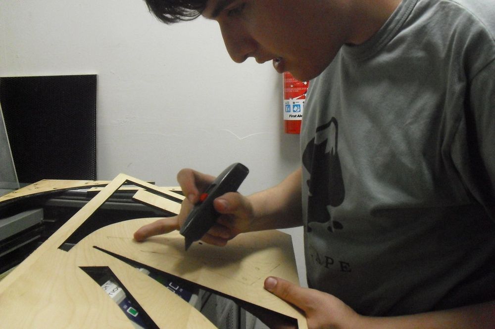 Detaching laser-cut wood pieces from a sheet
