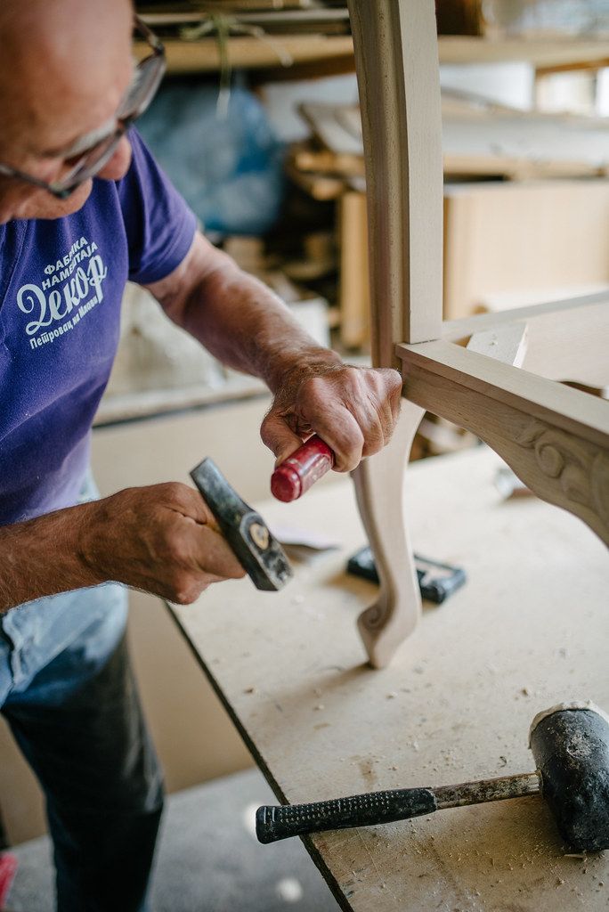Craftsman assembling a wooden chair by hand